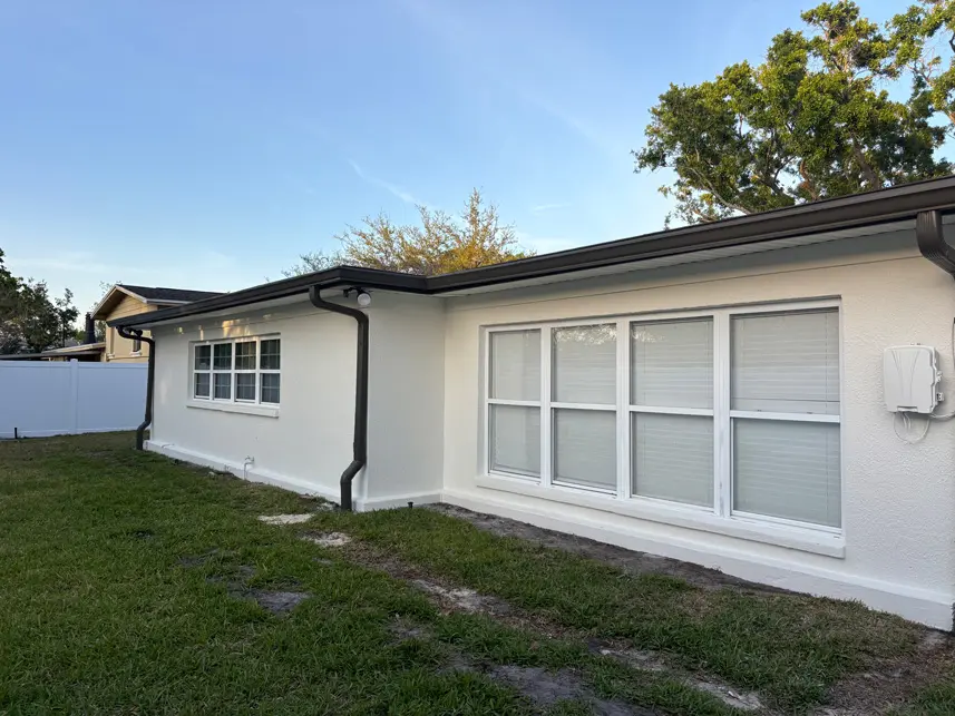 Back view of Tampa house after professional exterior painting with a clean white finish and contrasting trim