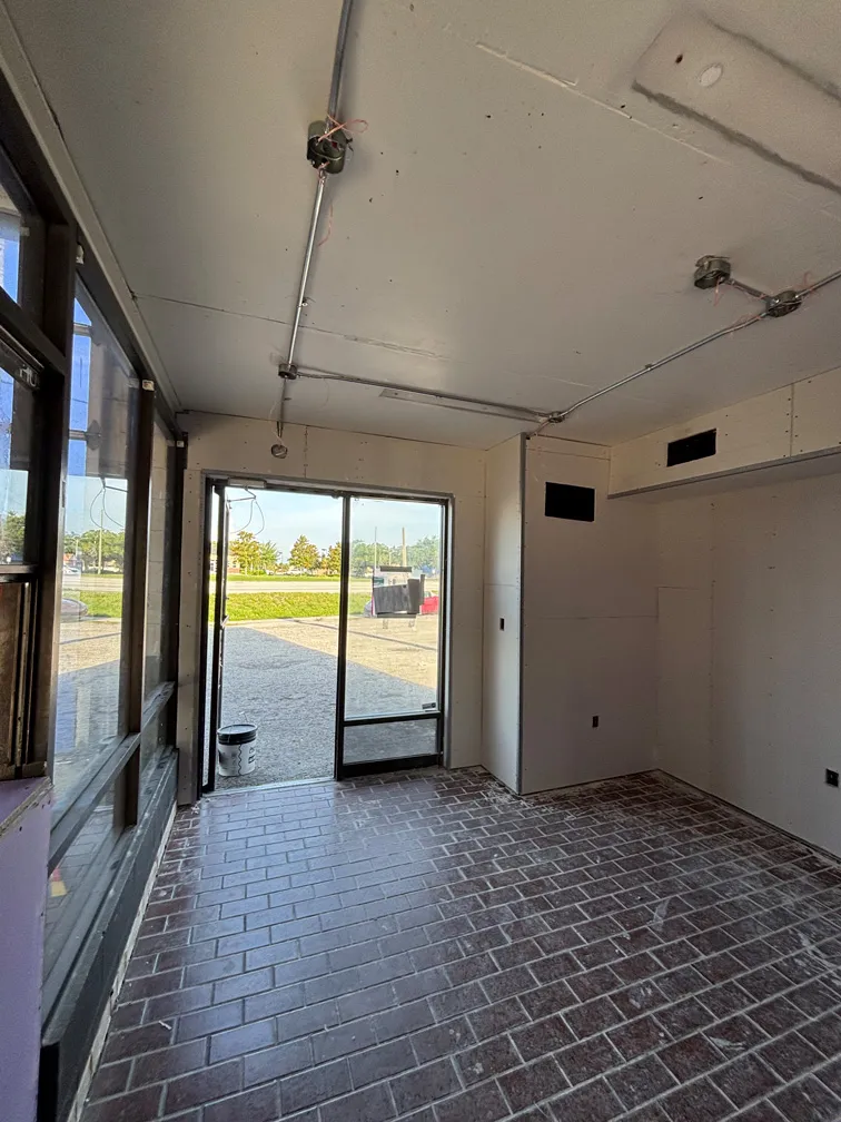 Interior view of drywall installation during car wash restoration in Winter Park, FL
