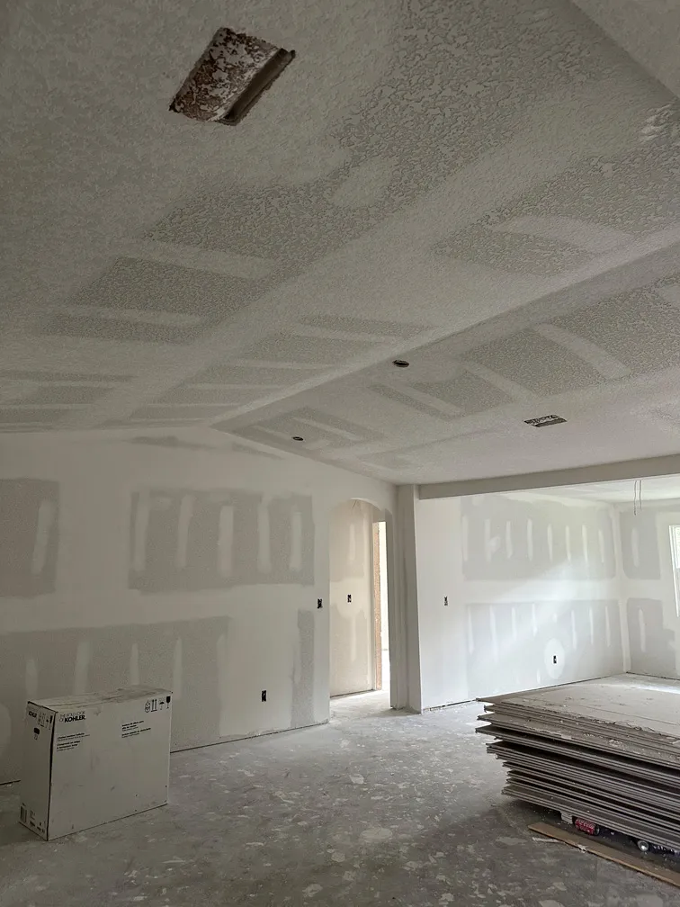 Living room with drywall and orange peel texture applied on ceiling and walls – North Tampa renovation
