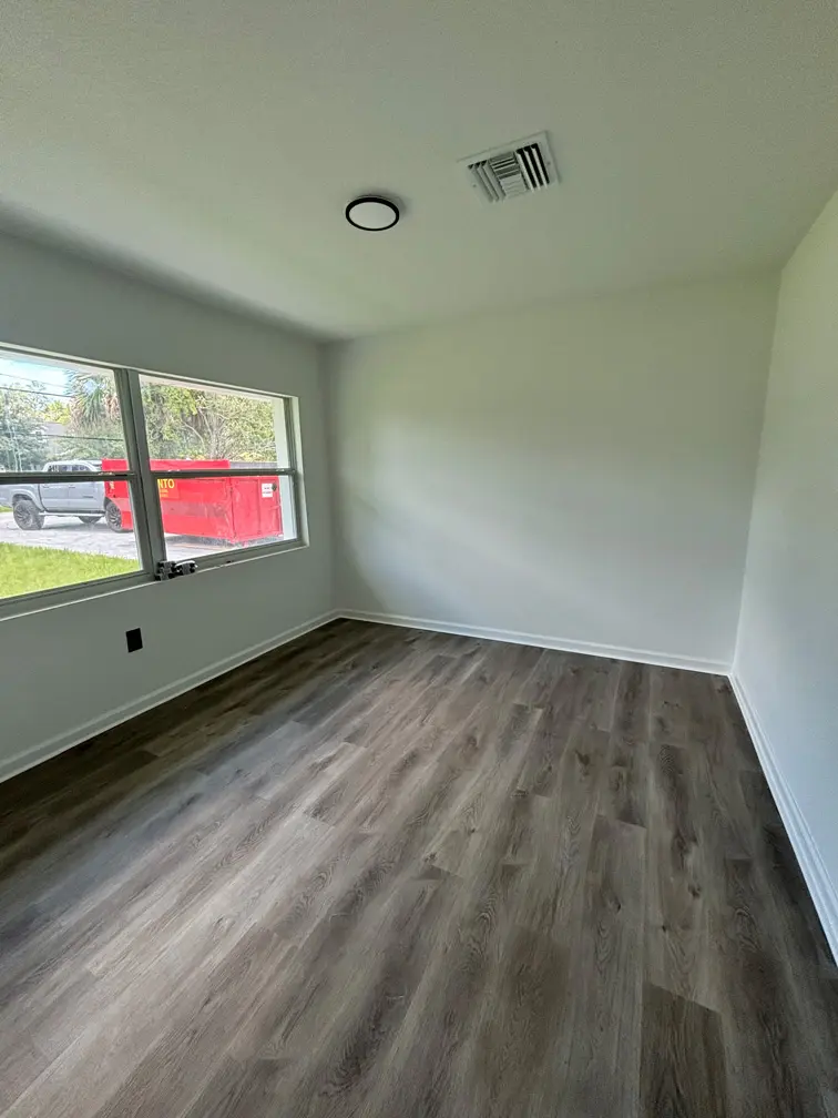 Finished bedroom remodel with new baseboards and wood flooring in Oviedo Florida