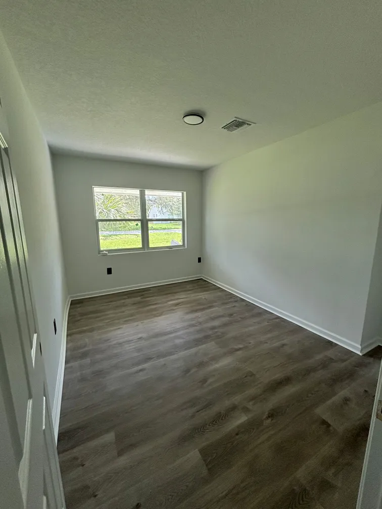 Small bedroom addition after complete remodel in Oviedo FL with new flooring and drywall finish