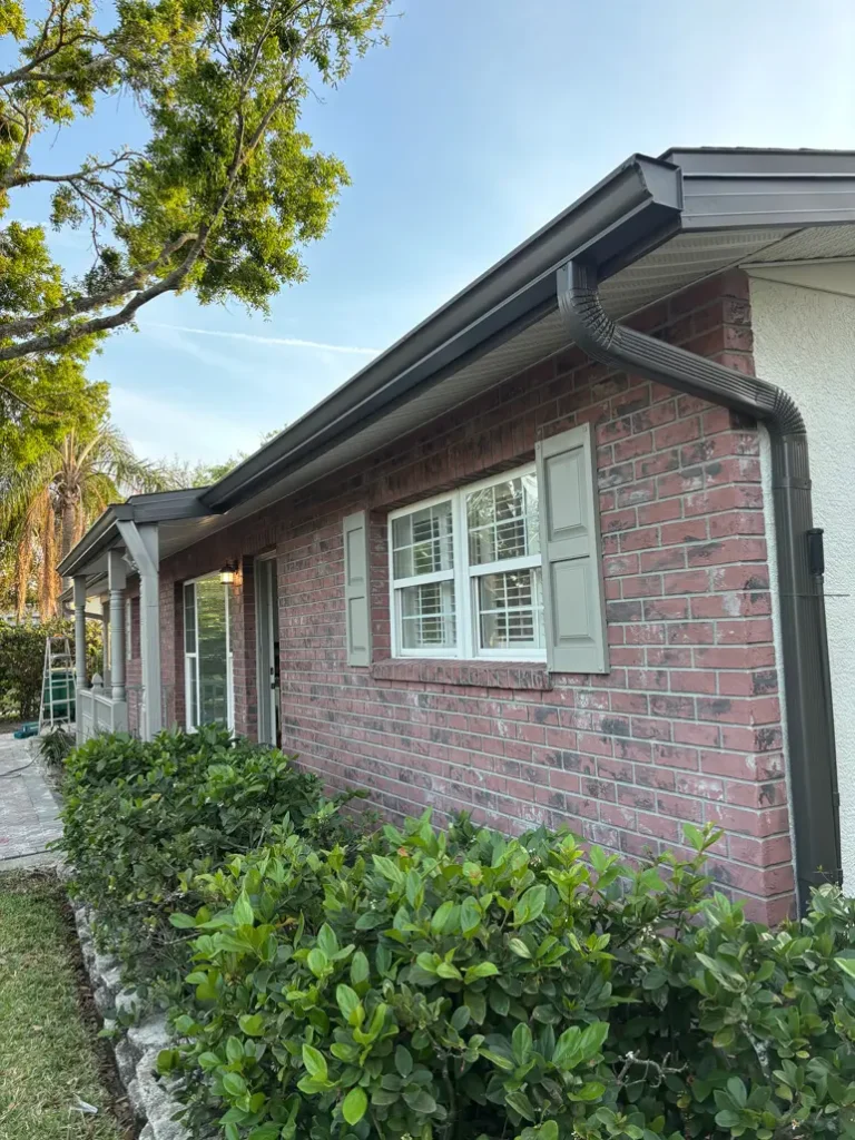 Front view of a house in Tampa before exterior painting, showing original brick facade and trim